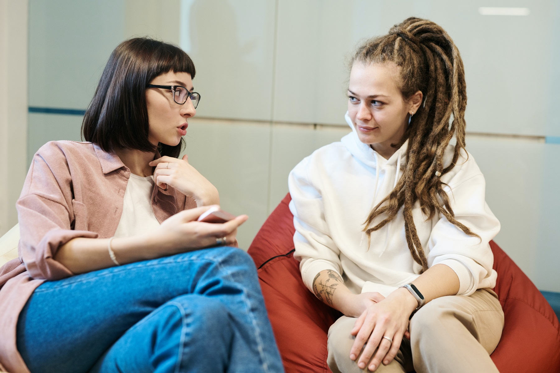 female teen conversing comfortably with female counselor